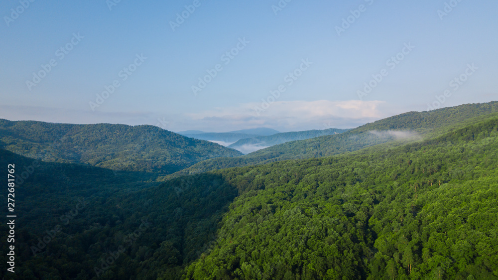 Obraz premium Aerial Landscape View of Caucasus mountain at sunny morning with fog.