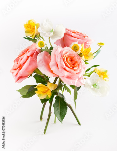 Beautiful bunch with coral roses with green leaves on white background