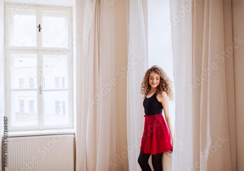 A portrait of young dance woman teacher indoors. Copy space.