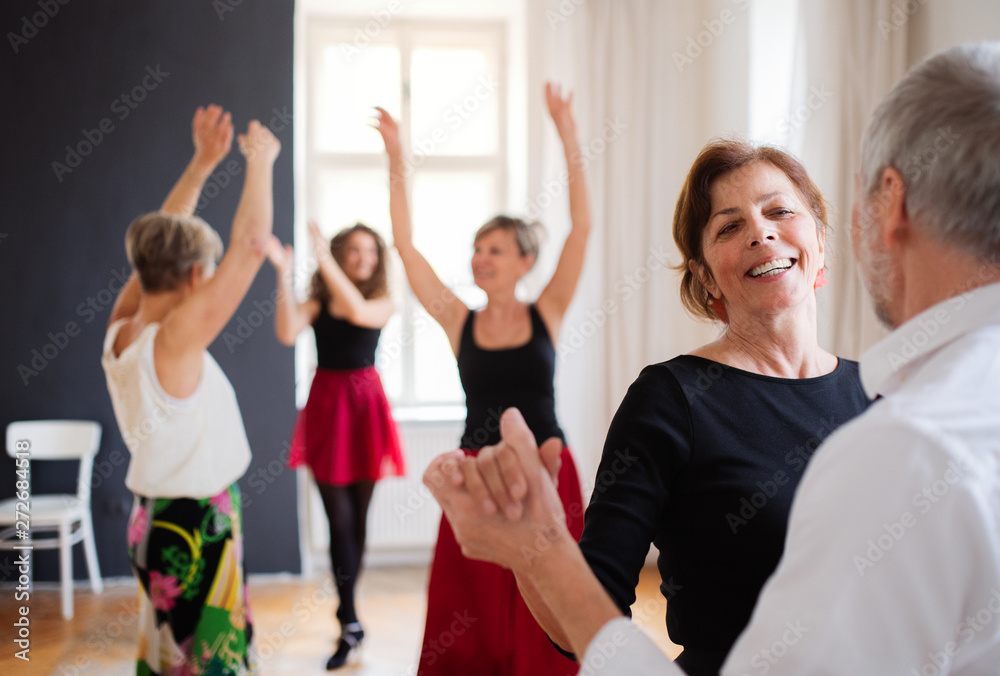 Fototapeta premium Group of senior people in dancing class with dance teacher.