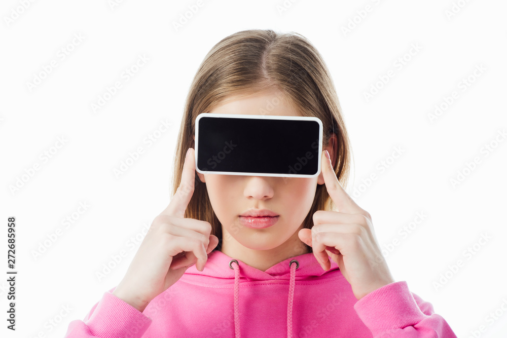 teenage girl in pink hoodie holding smartphone with blank screen in front of eyes isolated on white