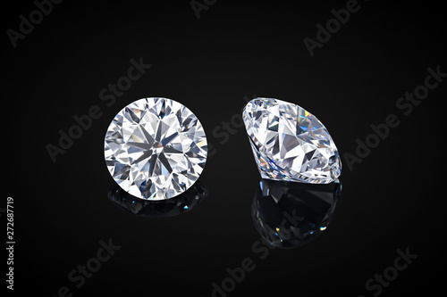 Diamond isolated on black background. Luxury colorless transparent sparkling gemstone diamond round shape cut