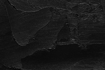 Texture of black crushed eyeliner or black acrylic paint