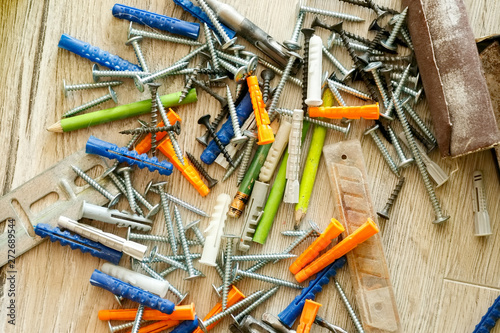 Pile of dowels and screws on the floor, close-up