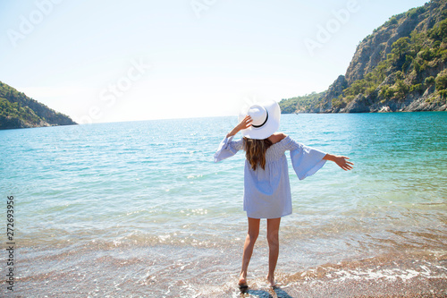 Beautiful young woman in standing at sea beach