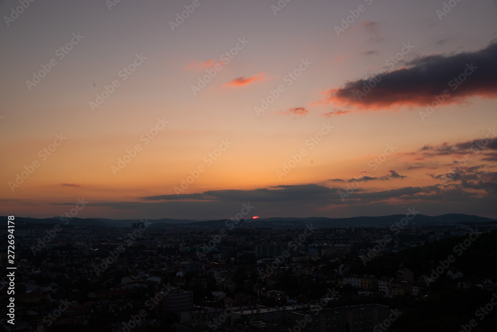 Colorful sunset on Bila Hora with beautiful view on city Brno, Czech Republic pink and orange colors with many clouds