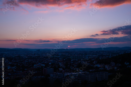 Colorful sunset on Bila Hora with beautiful view on city Brno, Czech Republic pink and orange colors with many clouds