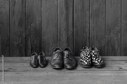 black shoes isolated on black wooden background © serikbaib