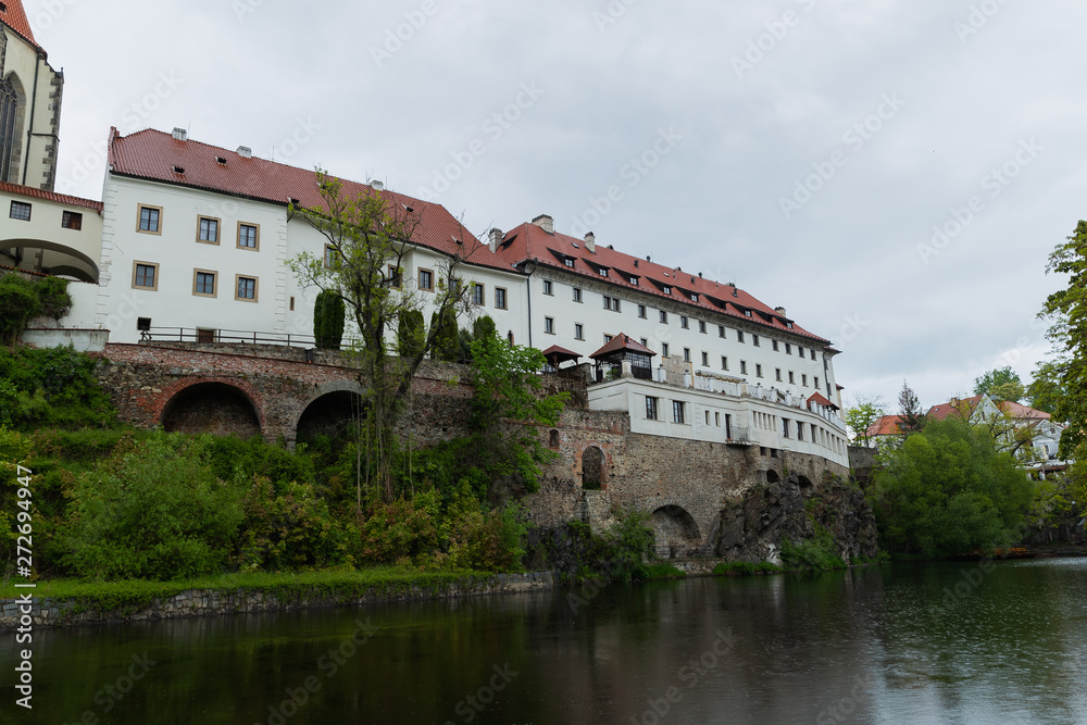 Panoramic landscape view on river Vltava in the historic city of Cesky Krumlov with famous Church city is on a UNESCO World Heritage Site captured during spring with nice sky and clouds