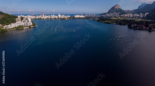 Vast city lake of Lagoa Rodrigo de Freitas in Rio de Janeiro on a bright day with a sailboat race and cityscape in the background