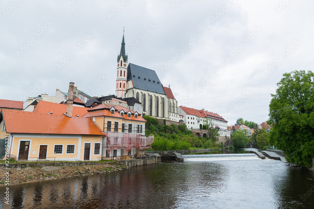 Panoramic landscape view of the historic city of Cesky Krumlov with famous Church city is on a UNESCO World Heritage Site captured during spring with nice sky and clouds