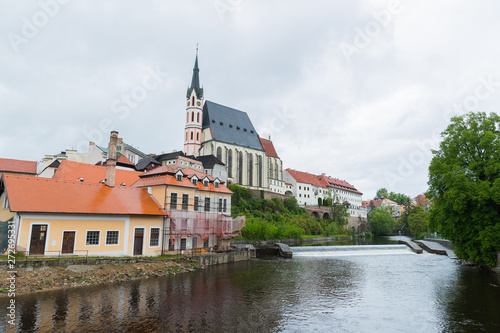 Panoramic landscape view of the historic city of Cesky Krumlov with famous Church city is on a UNESCO World Heritage Site captured during spring with nice sky and clouds