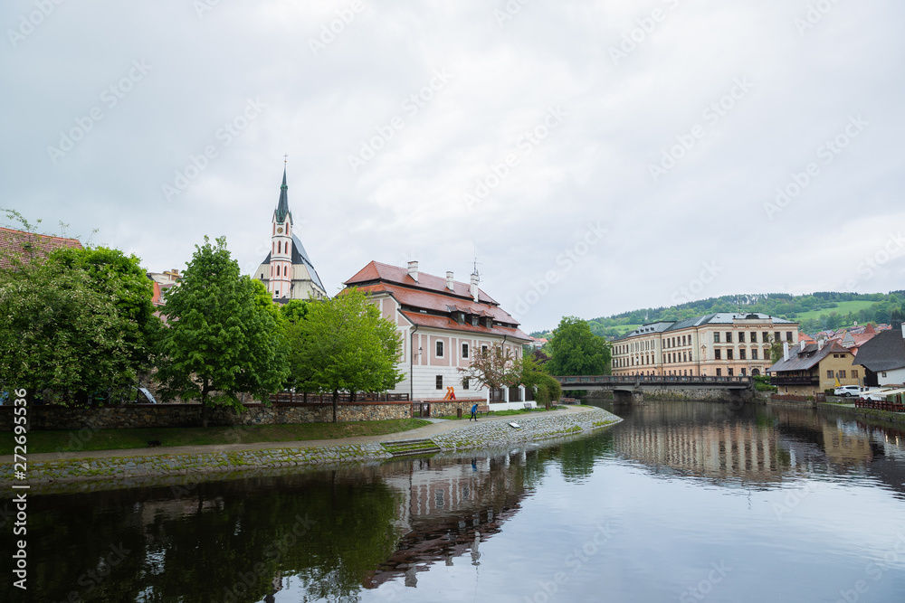 Panoramic landscape view on river Vltava in the historic city of Cesky Krumlov with famous Church city is on a UNESCO World Heritage Site captured during spring with nice sky and clouds