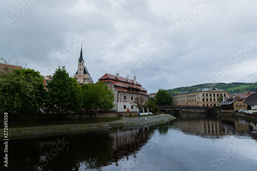 Panoramic landscape view on river Vltava in the historic city of Cesky Krumlov with famous Church city is on a UNESCO World Heritage Site captured during spring with nice sky and clouds © Lukas