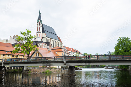 Panoramic landscape view on river Vltava in the historic city of Cesky Krumlov with famous Church city is on a UNESCO World Heritage Site captured during spring with nice sky and clouds © Lukas