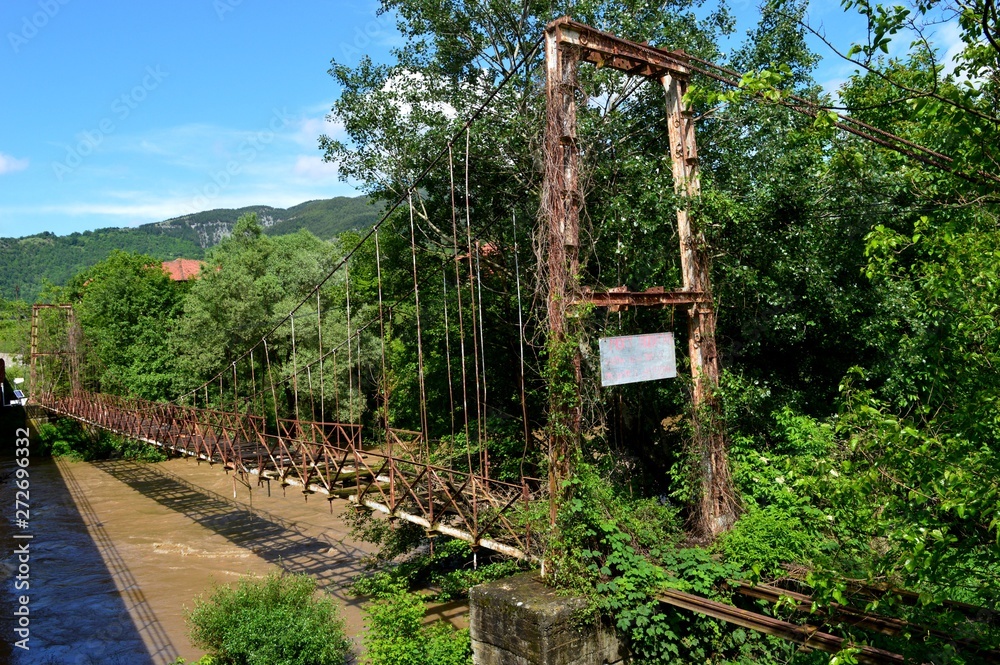 an old ruined bridge over the river