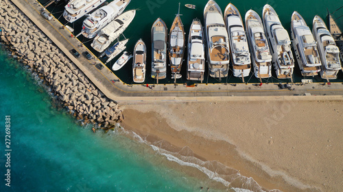 Aerial top view photo of luxury yachts docked in Marina Zeas and turquoise sandy beach of Freatida, Piraeus, Attica, Greece photo