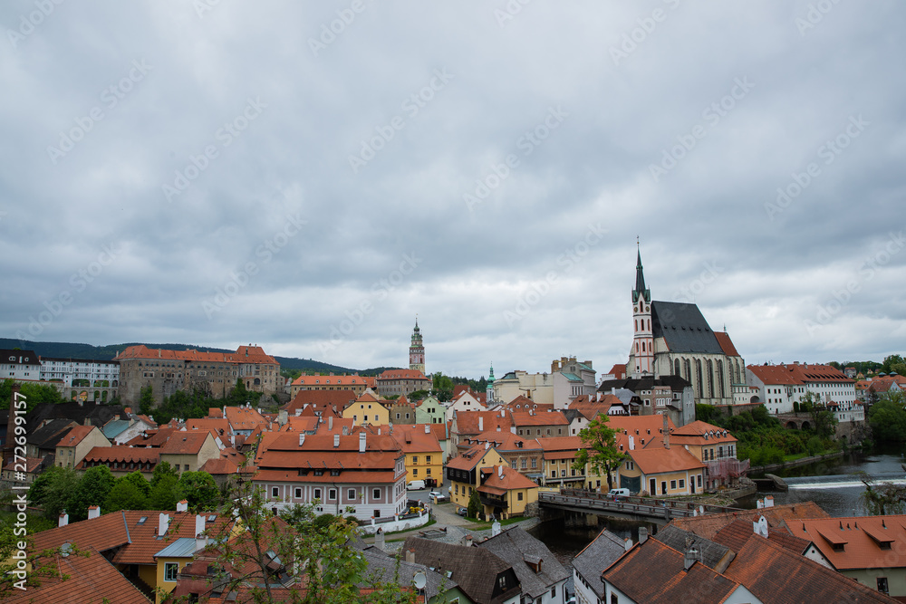 Panoramic landscape view of the historic city of Cesky Krumlov with famous Church city is on a UNESCO World Heritage Site captured during spring with nice sky and clouds