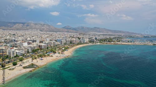 Aerial panoramic photo of famous seaside bay of Faliro with beautiful emerald sea, clouds and deep blue sky
