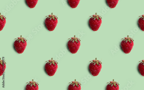 Fresh strawberries pattern isolated on green background. Summer Fruit.