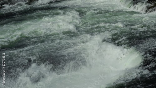 Water of the Rhine river just above the Rhine Falls waterfall in Switzerland
