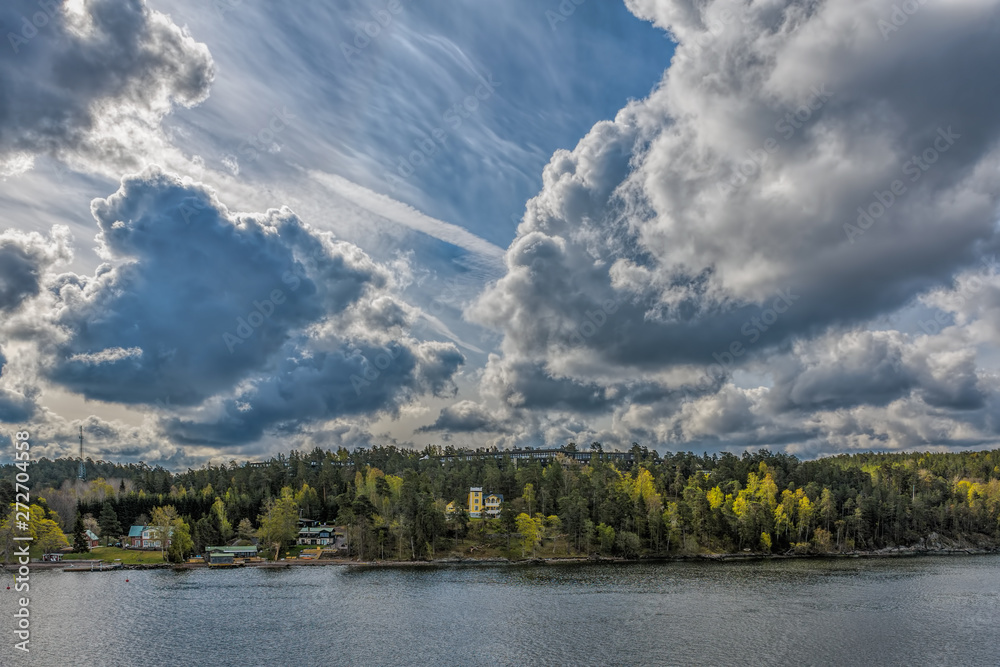 Fototapeta premium Amazing spring landscape with incredible cloudscape over Stockholm archipelago.