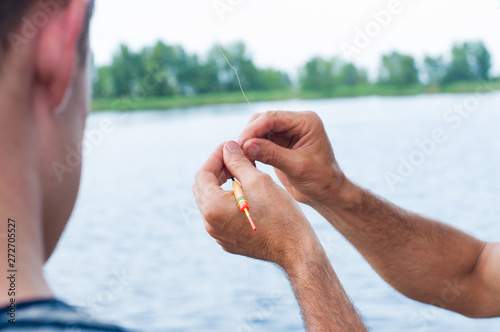 Father teaching son how to fishing in river