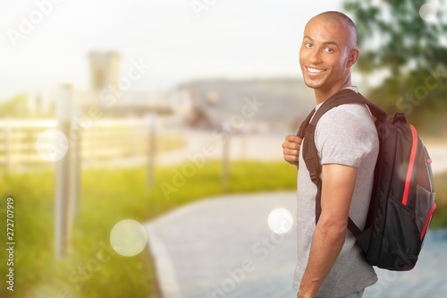 Fototapeta Naklejka Na Ścianę i Meble -  Male student with  backpack on  background