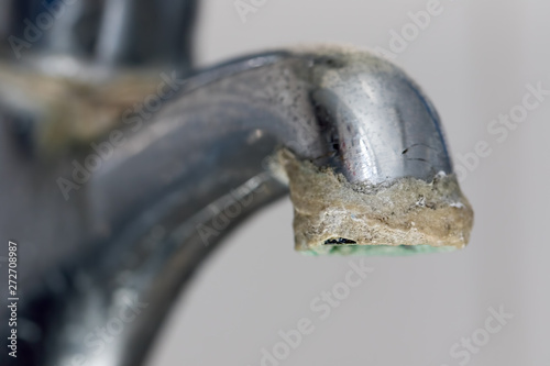 Close-up of limescale build-up. Selective focus on hard water deposit. photo
