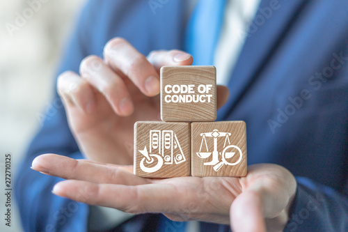 Code of conduct business concept on wooden blocks in businessman hands. Ethics and respect in working collective. photo