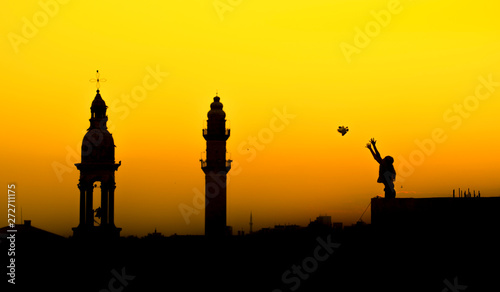 of woman flying a peace dove. Mardin mosque and church together