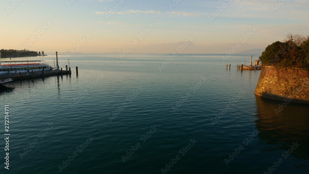 The blue waters of Lake Garda stretching up to the horizon. A popular destination for turistic trips to Italy.