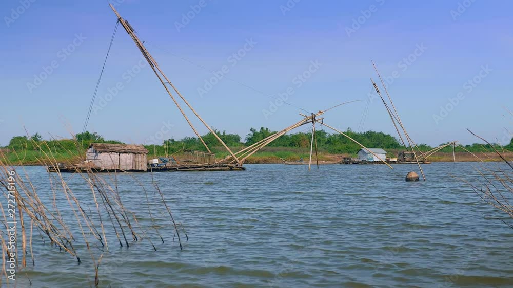 Houseboats and chinese fishing nets on river. (windy day) Houseboats and chinese fishing nets on river. (windy day)