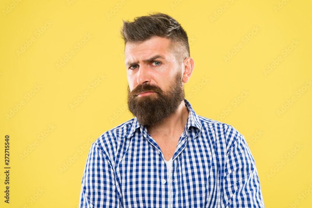 Beware of the facial hair. Serious hipster with long beard and stylish hair on yellow background. Brutal guy with shaped beard and mustache hair. Bearded man with unshaven face hair Beware of the facial hair. Serious hipster with long beard and stylish hair on yellow background. Brutal guy with shaped beard and mustache hair. Bearded man with unshaven face hair
