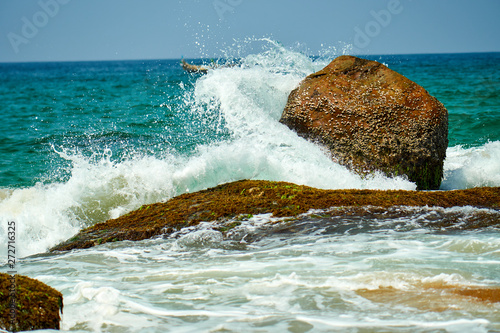 Ocean coast with big waves and rocks photo