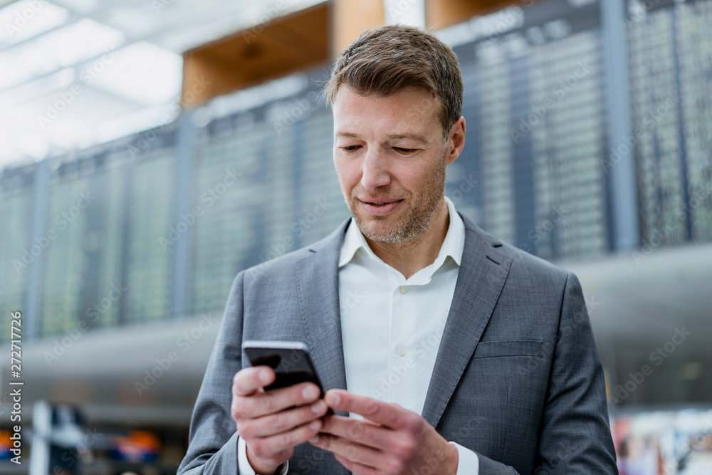 Portrait of businessman using cell phone at the airport Portrait of businessman using cell phone at the airport