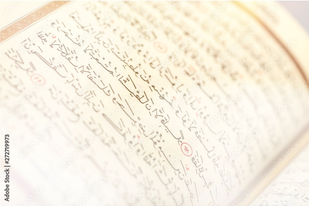 Islamic Book Koran with rosary on grey Islamic Book Koran with rosary on grey