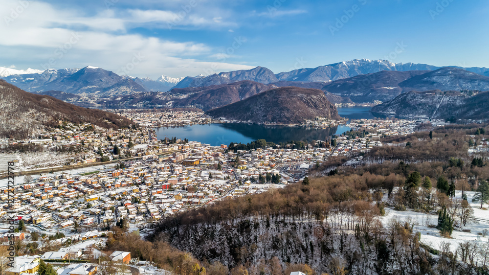 Aerial view of winter landscape of lake Lugano with Swiss Alps.