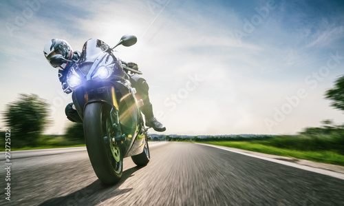 motorbike on the road riding. having fun riding the empty road on a motorcycle tour / journey