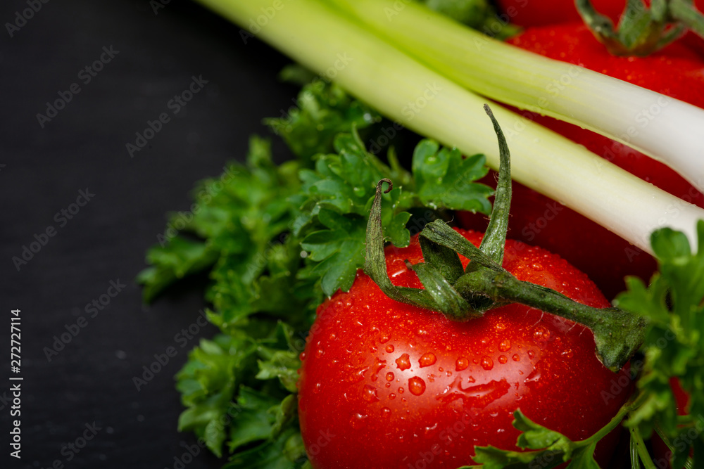 Φωτογραφία Organic Red Tomatoes on the vine, fresh Curly Parsley and Green Onion Scallions arranged on natural stone background