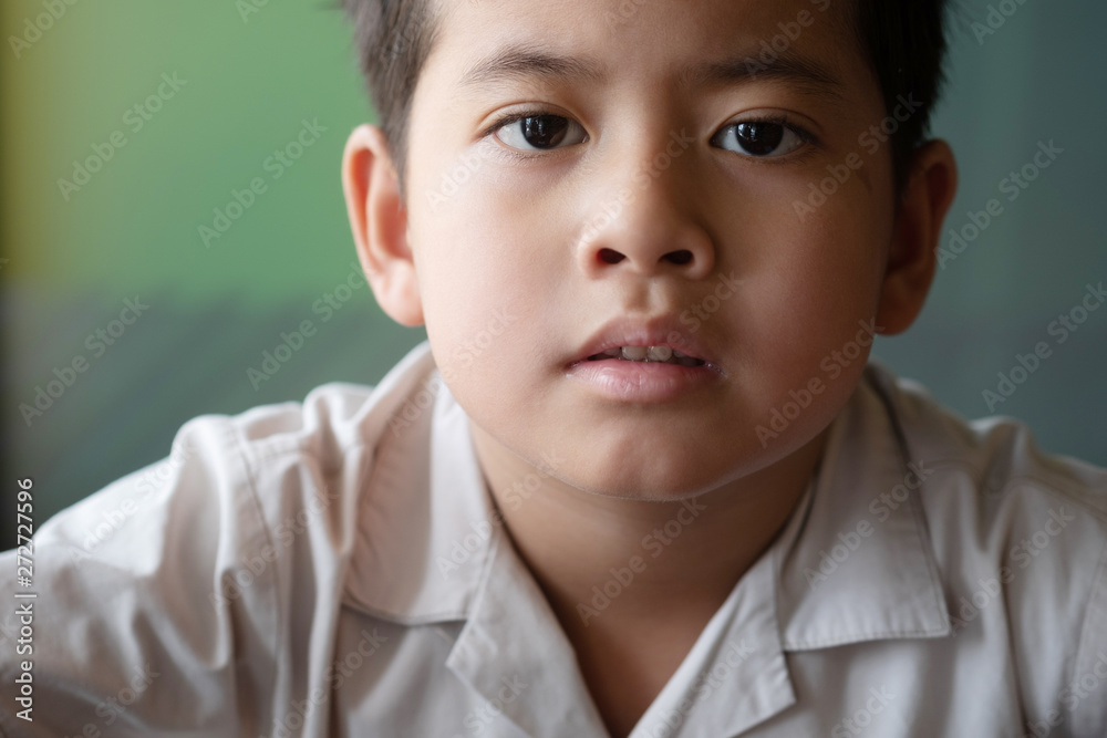 Close up asian boy showing feeling, isolated on blur background. Close up asian boy showing feeling, isolated on blur background.