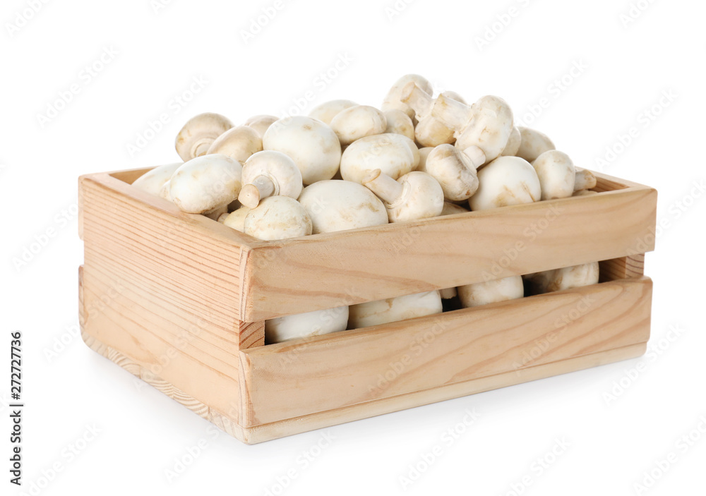 Wooden crate full of fresh raw mushrooms on white background Wooden crate full of fresh raw mushrooms on white background