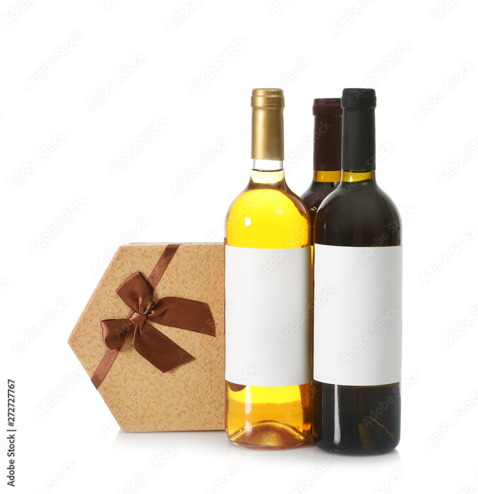 Bottles of wine and gift box on white background