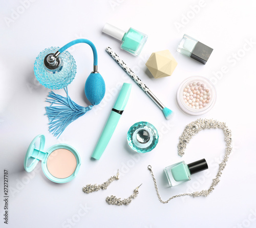 Composition with perfume bottles, cosmetics and accessories on white background, top view