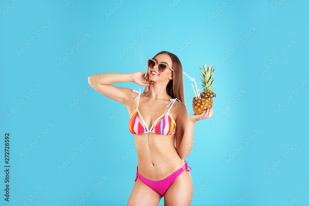 Pretty sexy woman in stylish bikini with cocktail on color background Pretty sexy woman in stylish bikini with cocktail on color background