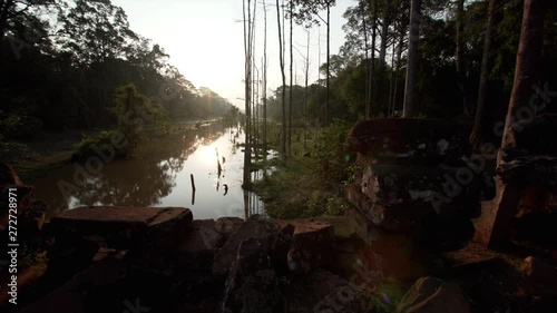 Picturesque sliding view of river flowig in jungles. Angkor Wat complex photo