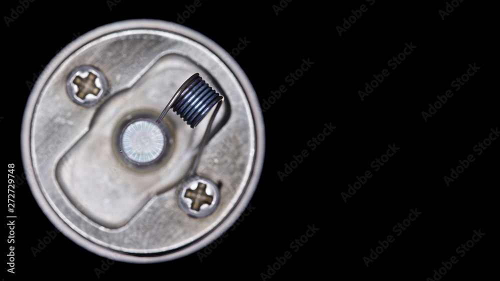 close up, macro shot, top view of single micro coil in high end rebuildable dripping atomizer for flavour chaser isolated on black background, vape gear, selective focus close up, macro shot, top view of single micro coil in high end rebuildable dripping atomizer for flavour chaser isolated on black background, vape gear, selective focus