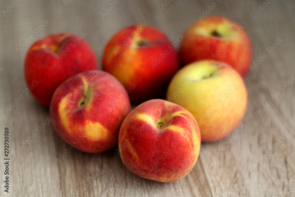 Fresh peaches on a wooden table. Selective focus. Fresh peaches on a wooden table. Selective focus.