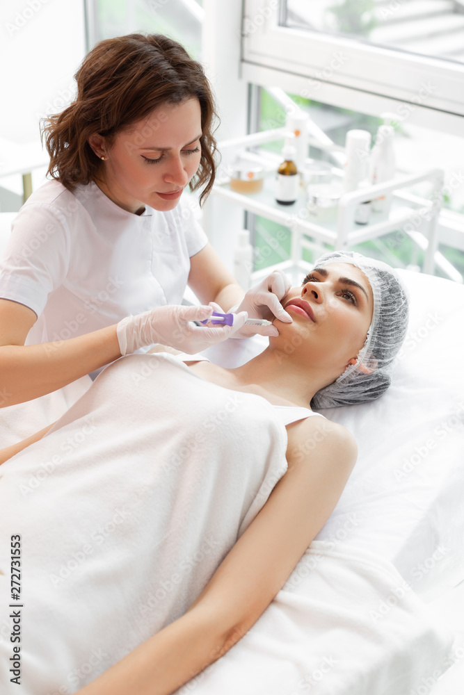 Serious hard working cosmetologist doing beauty injections Serious hard working cosmetologist doing beauty injections