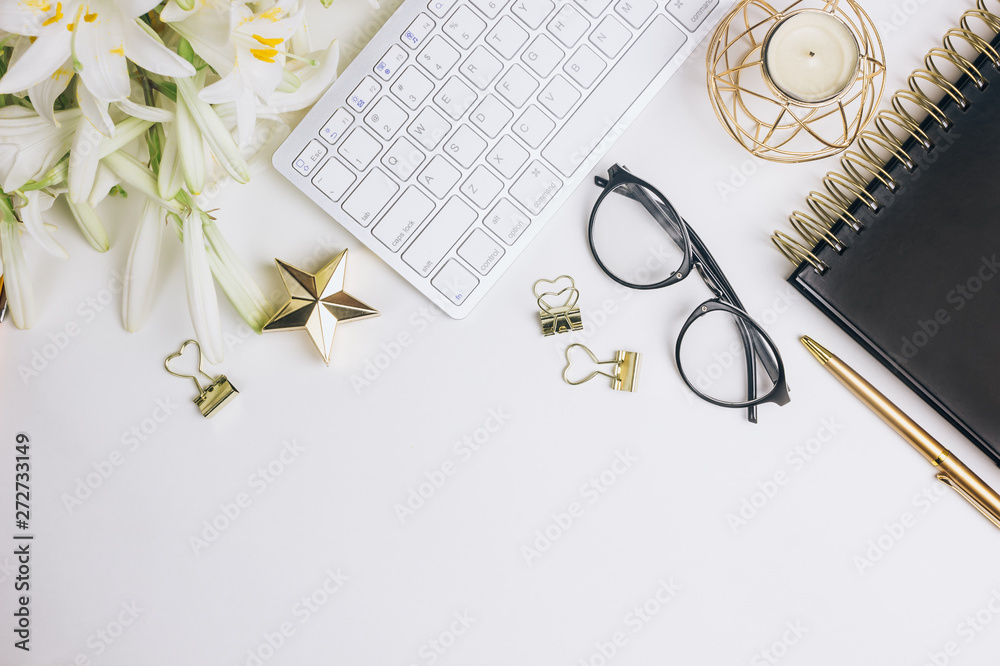 Flat lay home office desk. Female workspace with computer keyboard, golden accessories, glasses, black diary Flat lay home office desk. Female workspace with computer keyboard, golden accessories, glasses, black diary